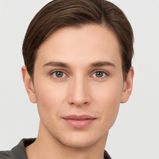 Joyful white young-adult male with short  brown hair and grey eyes