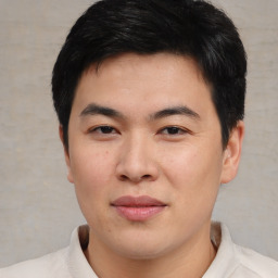 Joyful asian young-adult male with short  black hair and brown eyes