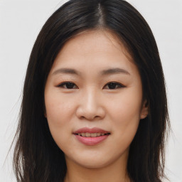 Joyful asian young-adult female with long  brown hair and brown eyes