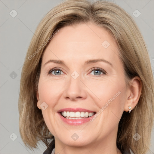 Joyful white adult female with medium  brown hair and grey eyes