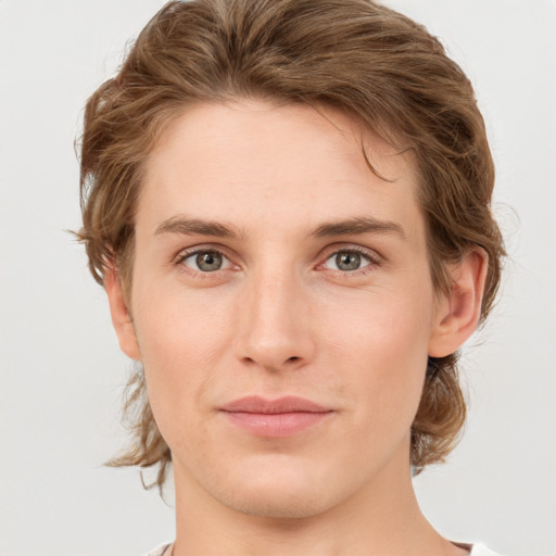 Joyful white young-adult male with medium  brown hair and grey eyes