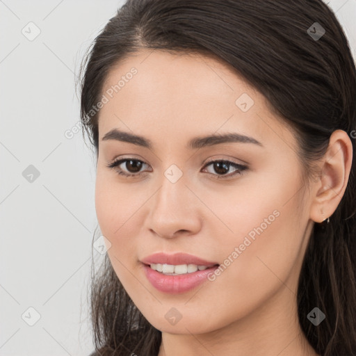 Joyful white young-adult female with long  brown hair and brown eyes