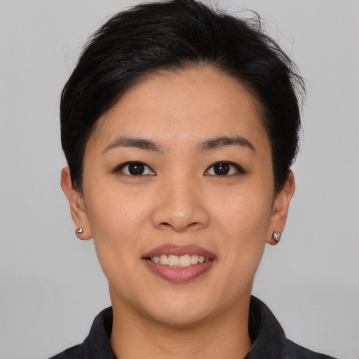 Joyful asian young-adult female with short  black hair and brown eyes