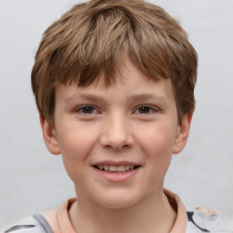 Joyful white child male with short  brown hair and brown eyes