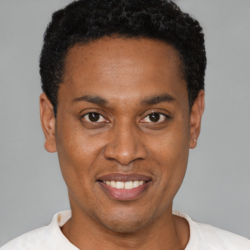 Joyful latino young-adult male with short  brown hair and brown eyes