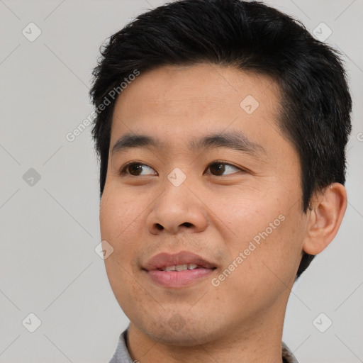 Joyful asian young-adult male with short  black hair and brown eyes