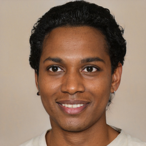 Joyful black young-adult male with short  black hair and brown eyes