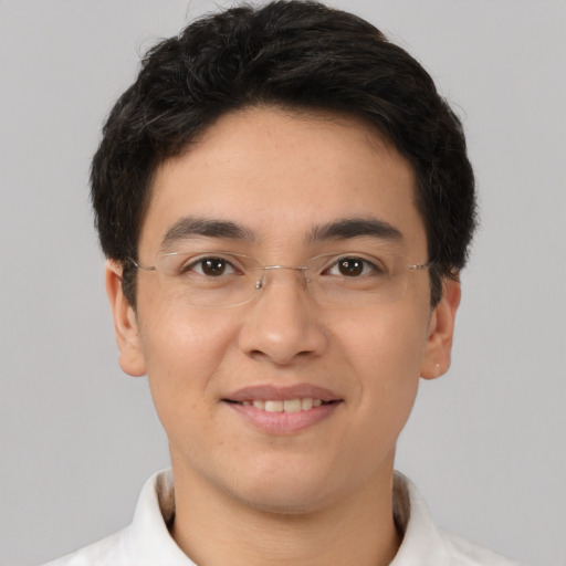 Joyful latino young-adult male with short  brown hair and brown eyes