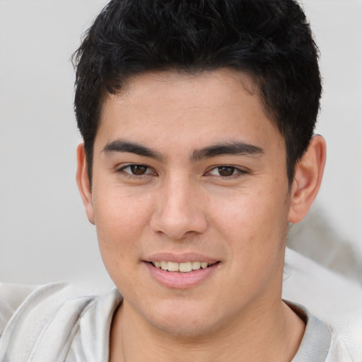 Joyful asian young-adult male with short  brown hair and brown eyes