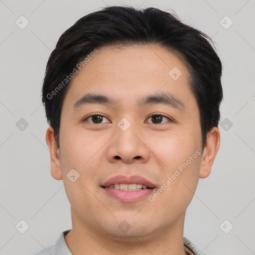 Joyful asian young-adult male with short  brown hair and brown eyes