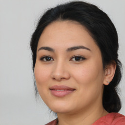 Joyful latino young-adult female with medium  brown hair and brown eyes