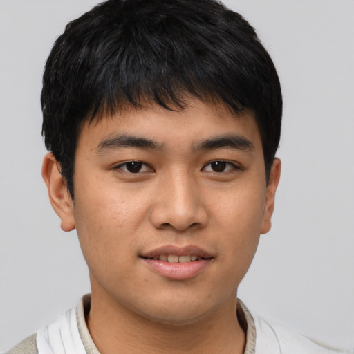 Joyful asian young-adult male with short  brown hair and brown eyes