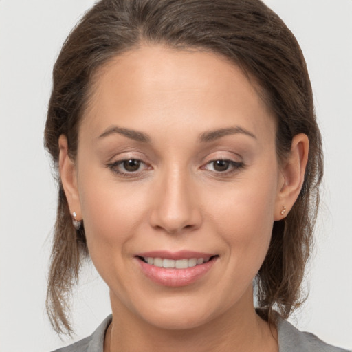 Joyful white young-adult female with medium  brown hair and brown eyes