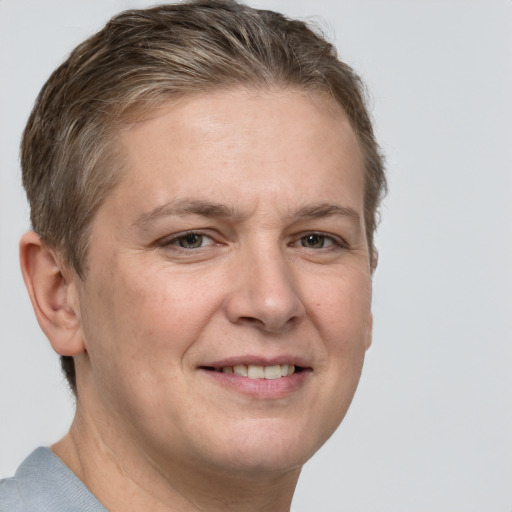 Joyful white adult female with short  brown hair and grey eyes