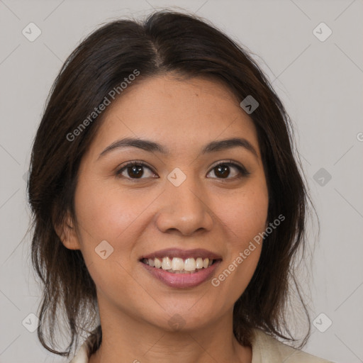 Joyful latino young-adult female with medium  brown hair and brown eyes