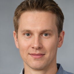 Joyful white adult male with short  brown hair and grey eyes