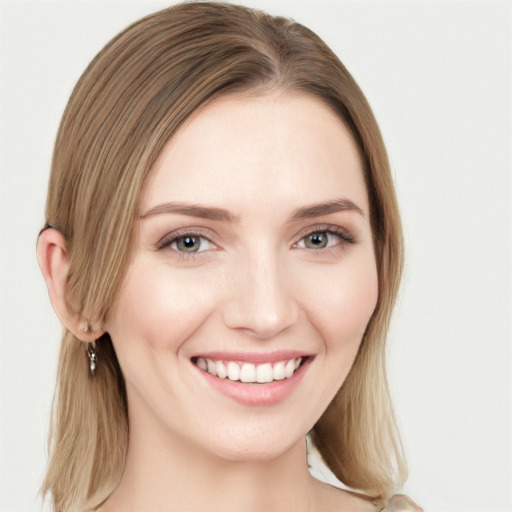 Joyful white young-adult female with long  brown hair and green eyes