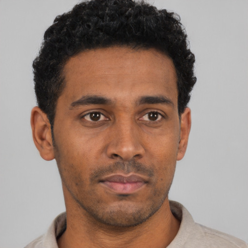 Neutral black young-adult male with short  black hair and brown eyes