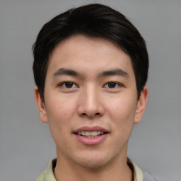 Joyful asian young-adult male with short  brown hair and brown eyes