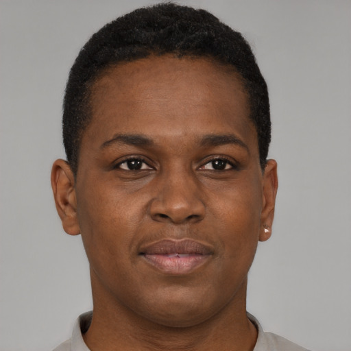 Joyful black young-adult male with short  brown hair and brown eyes