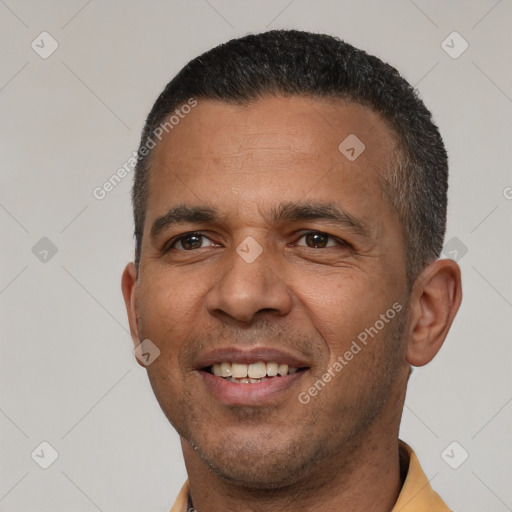 Joyful latino adult male with short  brown hair and brown eyes