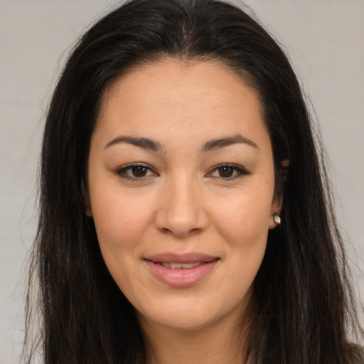 Joyful asian young-adult female with long  brown hair and brown eyes