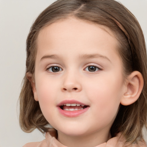 Joyful white child female with medium  brown hair and grey eyes