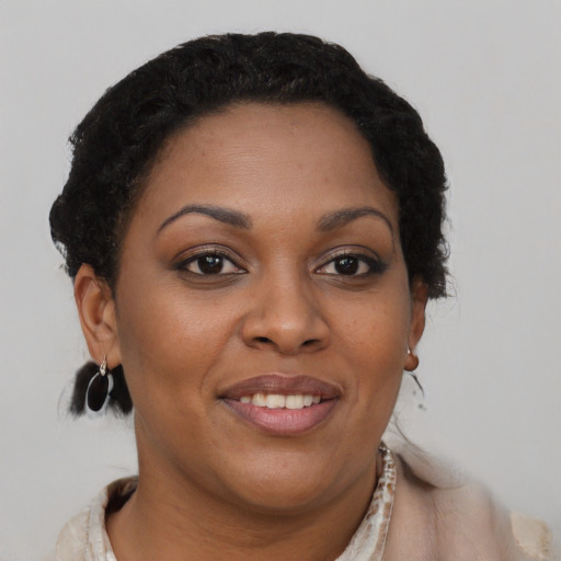 Joyful black young-adult female with short  brown hair and brown eyes