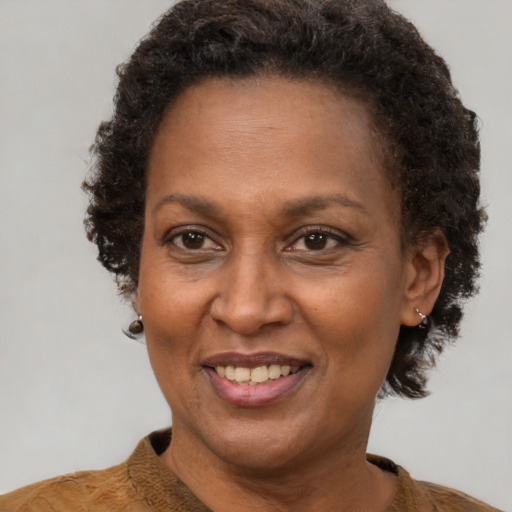 Joyful black adult female with short  brown hair and brown eyes