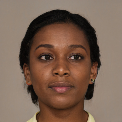 Joyful black young-adult female with medium  brown hair and brown eyes