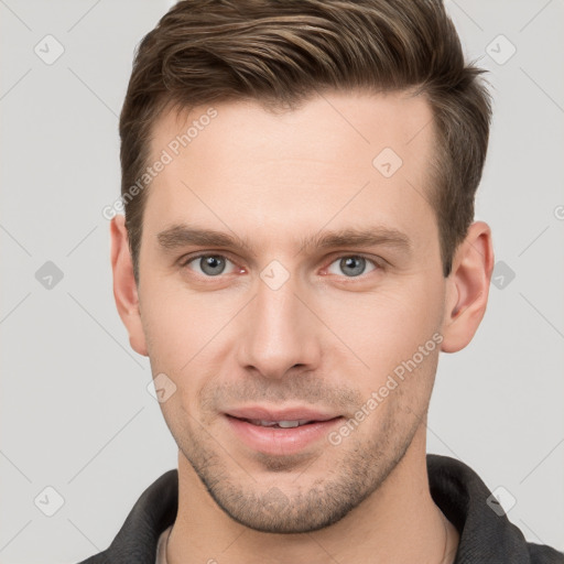 Joyful white young-adult male with short  brown hair and grey eyes