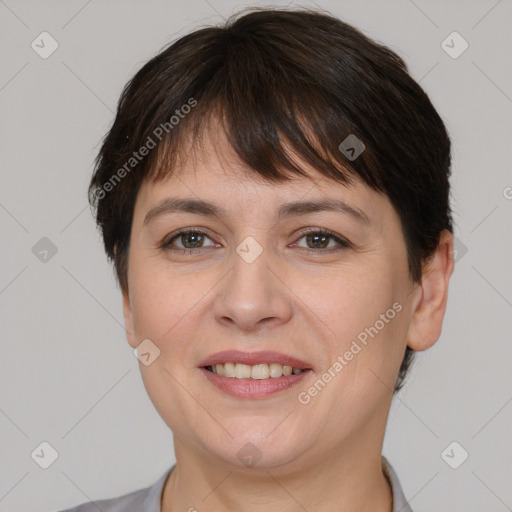 Joyful white adult female with short  brown hair and brown eyes