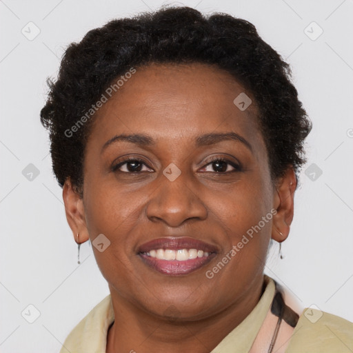 Joyful black adult female with short  brown hair and brown eyes