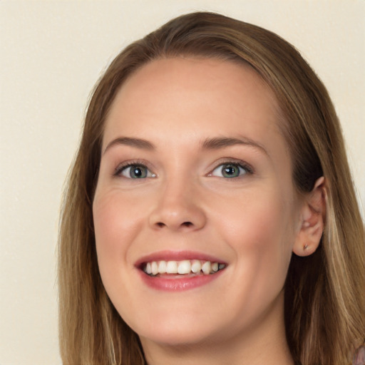 Joyful white young-adult female with long  brown hair and blue eyes