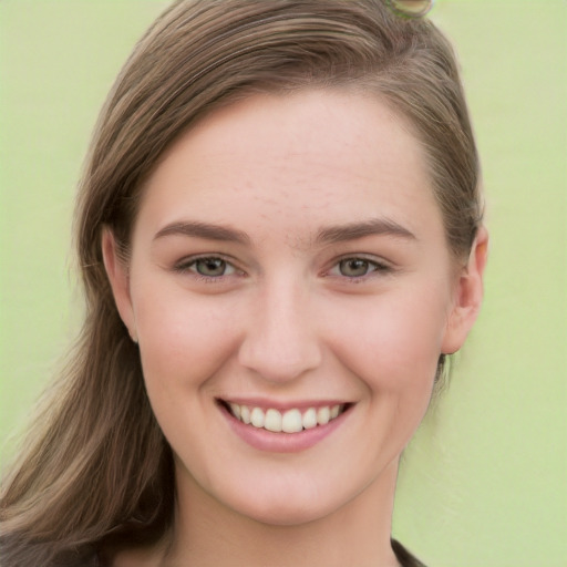 Joyful white young-adult female with long  brown hair and green eyes