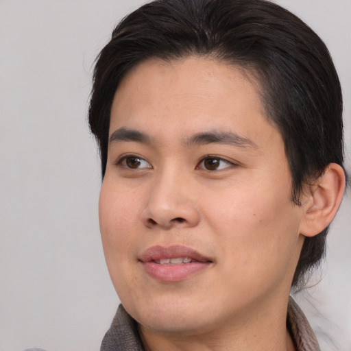 Joyful asian young-adult male with medium  brown hair and brown eyes