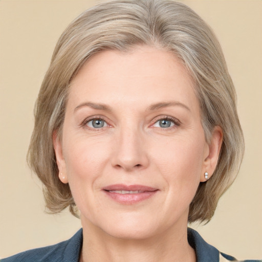 Joyful white adult female with medium  brown hair and grey eyes