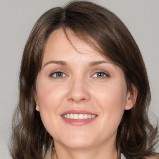 Joyful white young-adult female with medium  brown hair and brown eyes