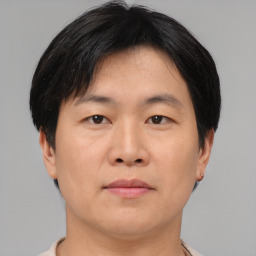 Neutral asian adult male with short  brown hair and brown eyes