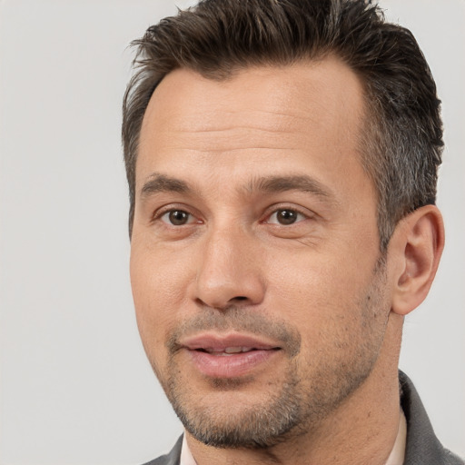 Joyful white adult male with short  brown hair and brown eyes