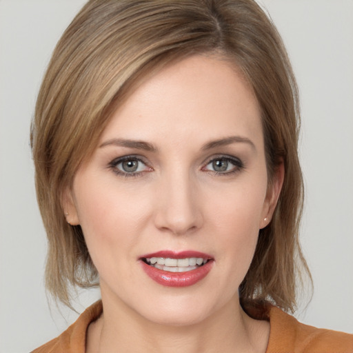 Joyful white young-adult female with medium  brown hair and grey eyes