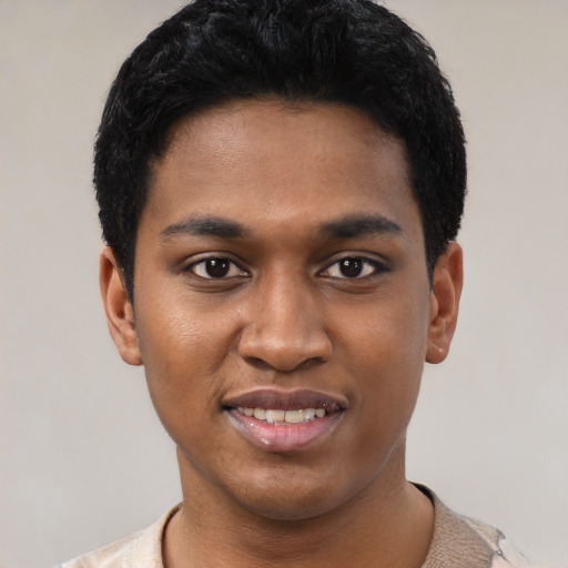Joyful black young-adult male with short  black hair and brown eyes