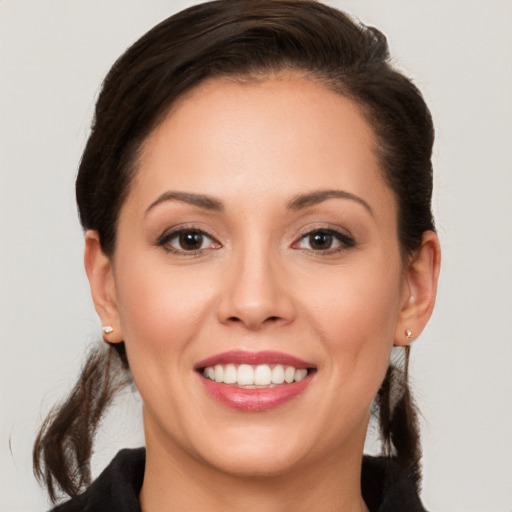 Joyful white young-adult female with long  brown hair and brown eyes