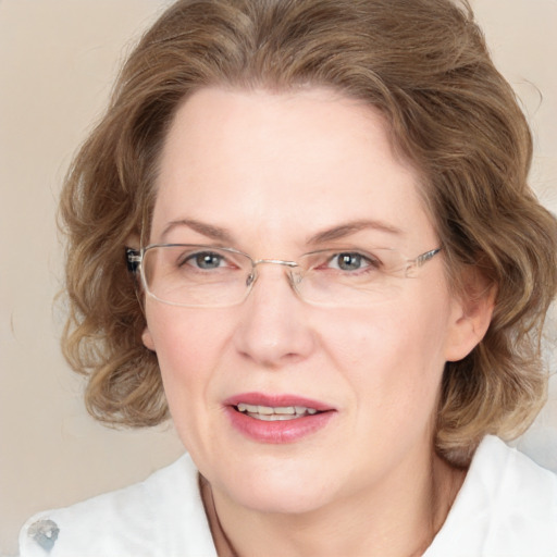 Joyful white adult female with medium  brown hair and blue eyes