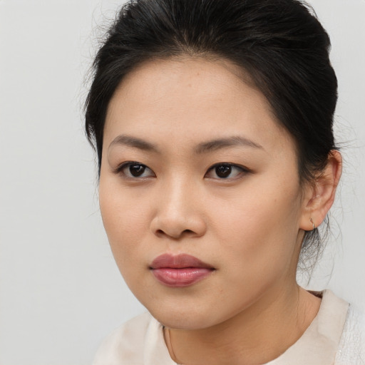 Joyful asian young-adult female with medium  brown hair and brown eyes