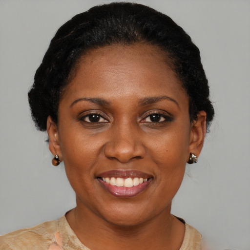 Joyful black young-adult female with short  black hair and brown eyes
