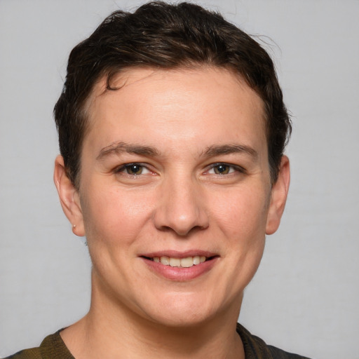 Joyful white young-adult female with short  brown hair and grey eyes