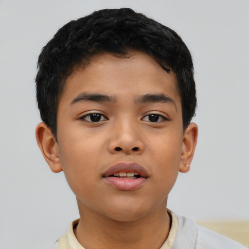 Joyful latino child male with short  brown hair and brown eyes