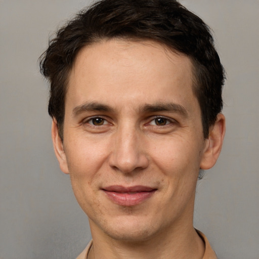 Joyful white adult male with short  brown hair and brown eyes