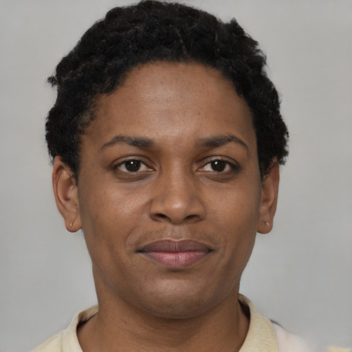 Joyful black young-adult female with short  brown hair and brown eyes